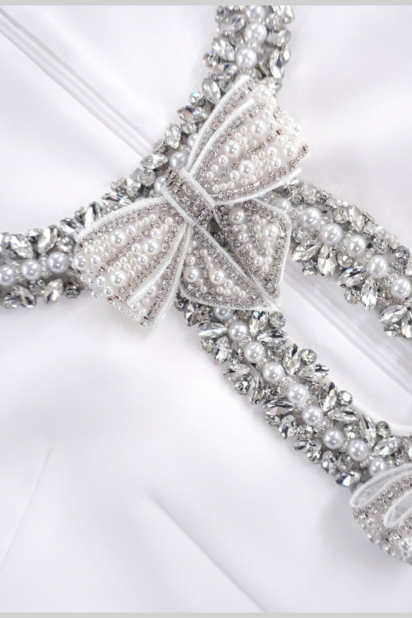 Sleeveless Mini Dress With Intricate Sparkling Neckline And Bow Embellishments - White