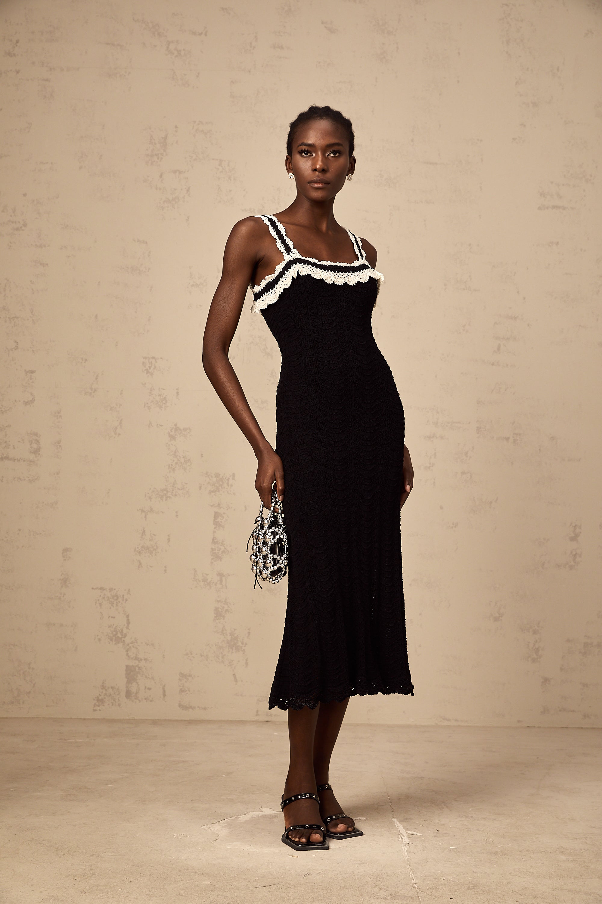 Noémie black sleeveless crochet-knit midi dress