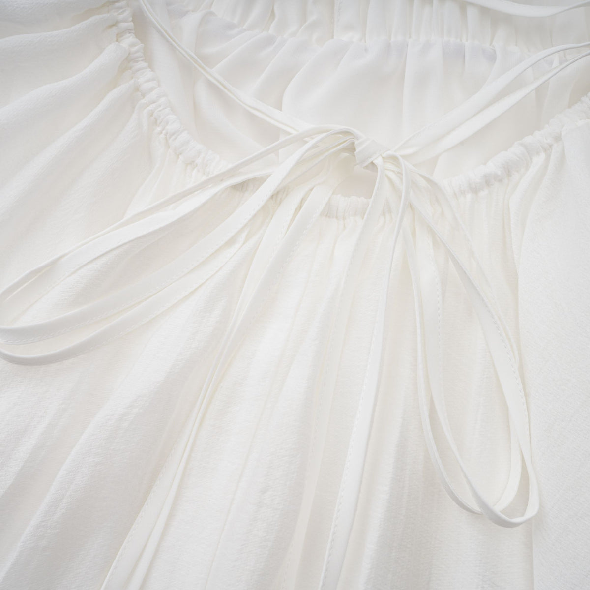 Quincie white shirred flounced mini dress